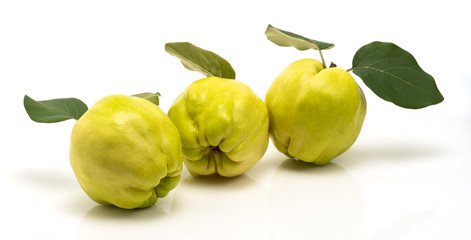 Group of ripe yellow quinces isolated on white background.