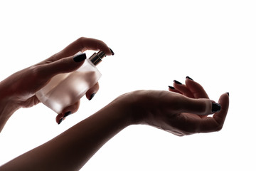 girl sprays perfume on her wrist
