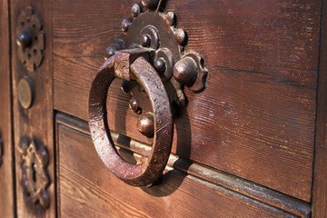 Antique door handle on a wooden door