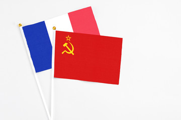 Soviet Union and France stick flags on white background. High quality fabric, miniature national flag. Peaceful global concept.White floor for copy space.