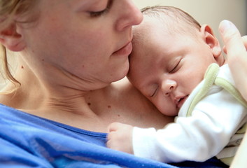 baby with his mother been cared for after having a good night sleep in bed at home stock photo 