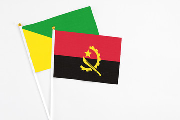 Angola and French Guiana stick flags on white background. High quality fabric, miniature national...
