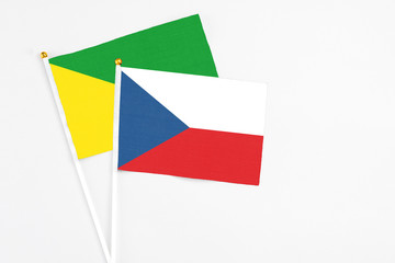 Czech Republic and French Guiana stick flags on white background. High quality fabric, miniature national flag. Peaceful global concept.White floor for copy space.