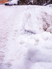 Large pieces of frozen snow on the side of the road - selective focus