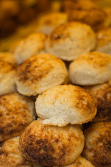 Coconut macaroons, italian dessert,  baked and stacked on top of one another at a food festival, yellow, sweet almond baked in oven and delicious