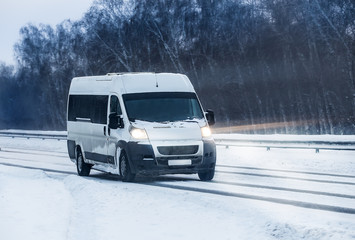 Minibus moves in the winter on a highway