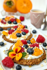 Granola fruit Tarts with yogurt and berries. Mini fruit pizza.