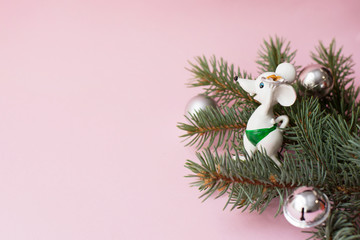 Happy new year 2020 white mouse and fir branch on pink background, copy space