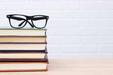 glasses on top of stacked books