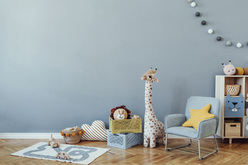 Scandinavian nursery room with wooden cabinet, mint armchair, natural teddy bears and plush animal...