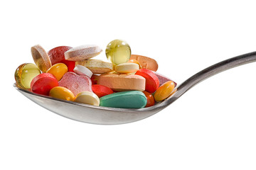 Various drugs vitamins and nutrition supplements on spoon
