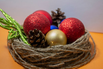 Christmas toys and decorations, a twig nest and Christmas balls