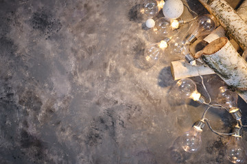 Christmas background with wood tree and decor. Top view with copy space and lighting bulb