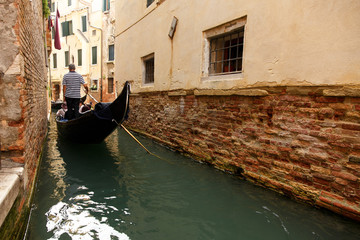 Fototapeta na wymiar Gondolier on gondola, Venice, Italy