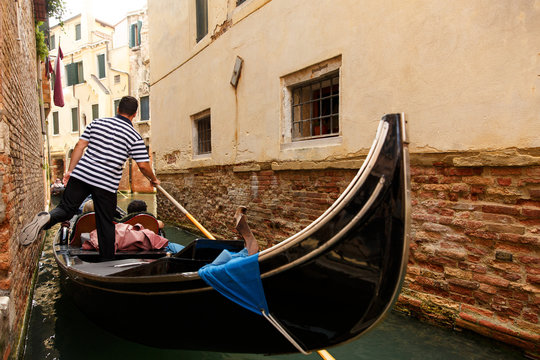 Gondolier on gondola, Venice, Italy