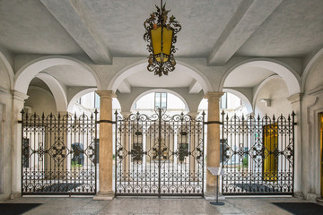 Beautiful yard with arches, forged gate and a hanging chandelier