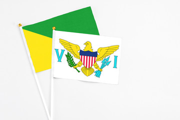 United States Virgin Islands and French Guiana stick flags on white background. High quality fabric, miniature national flag. Peaceful global concept.White floor for copy space.