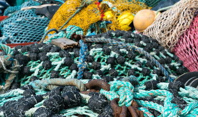 large pile of different fishing nets used for offshore fishing and trawling laying on the docks