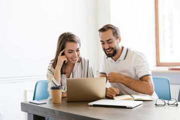 Positive pleased couple colleagues talking with each other.