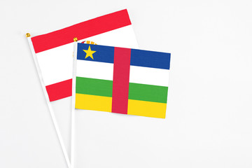 Central African Republic and French Polynesia stick flags on white background. High quality fabric, miniature national flag. Peaceful global concept.White floor for copy space.