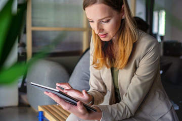 Young women typing on digital tablet	