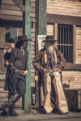 The sheriff was standing there talking with his followers in front of the station. In order to find...