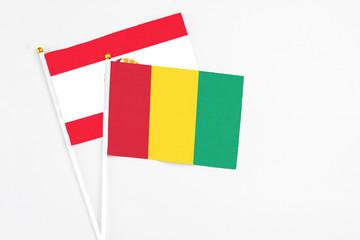 Guinea and French Polynesia stick flags on white background. High quality fabric, miniature...