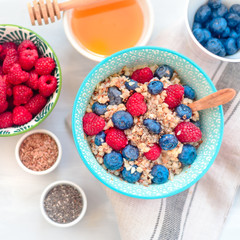 breakfast buckwheat porridge with raspberries and blueberries, good morning concept