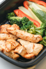 Food delivery in macro. Dishes in containers on a bright background.