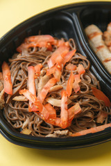Food delivery in macro. Dishes in containers on a bright background.