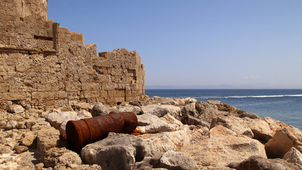 Old rusty cannon near the walls of Fort of Saint Nicholas, Mandraki Harbour, Rhodes, Greece