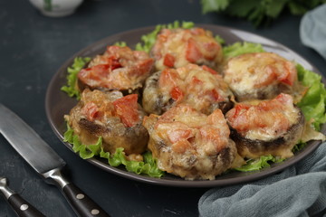 Baked champignons stuffed with tomatoes under suluguni cheese, a festive hot snack of Georgian cuisine