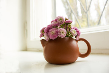 bouquet of flowers in vase on the window