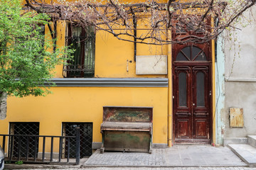 Vintage yellow house and wooden door overlooking the street