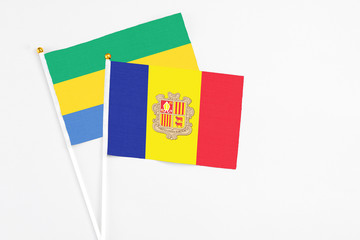 Andorra and Gabon stick flags on white background. High quality fabric, miniature national flag....