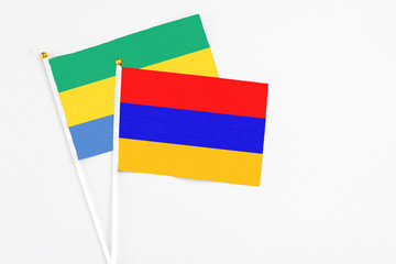 Armenia and Gabon stick flags on white background. High quality fabric, miniature national flag....