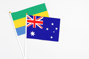Australia and Gabon stick flags on white background. High quality fabric, miniature national flag....