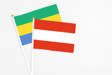 Austria and Gabon stick flags on white background. High quality fabric, miniature national flag....