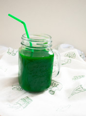 green natural smoothie on a white table