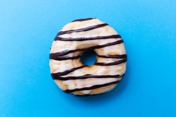 Delicious donut on blue background.