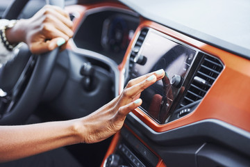 Close up view of african american woman's hands inside of new modern car