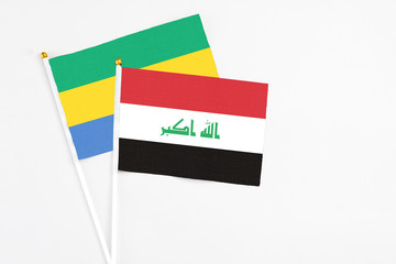 Iraq and Gabon stick flags on white background. High quality fabric, miniature national flag....