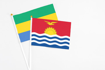 Kiribati and Gabon stick flags on white background. High quality fabric, miniature national flag....