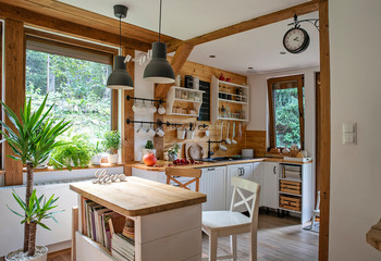 Interior of kitchen in rustic style with vintage kitchen ware and window. White furniture and...