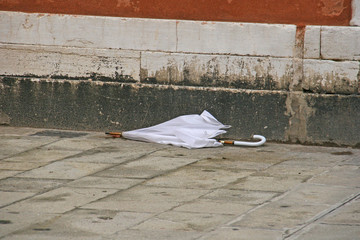 broken white umbrella in street of Venice