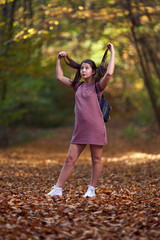 Schoolgirl walking in the forest