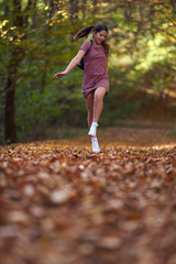 Schoolgirl walking in the forest