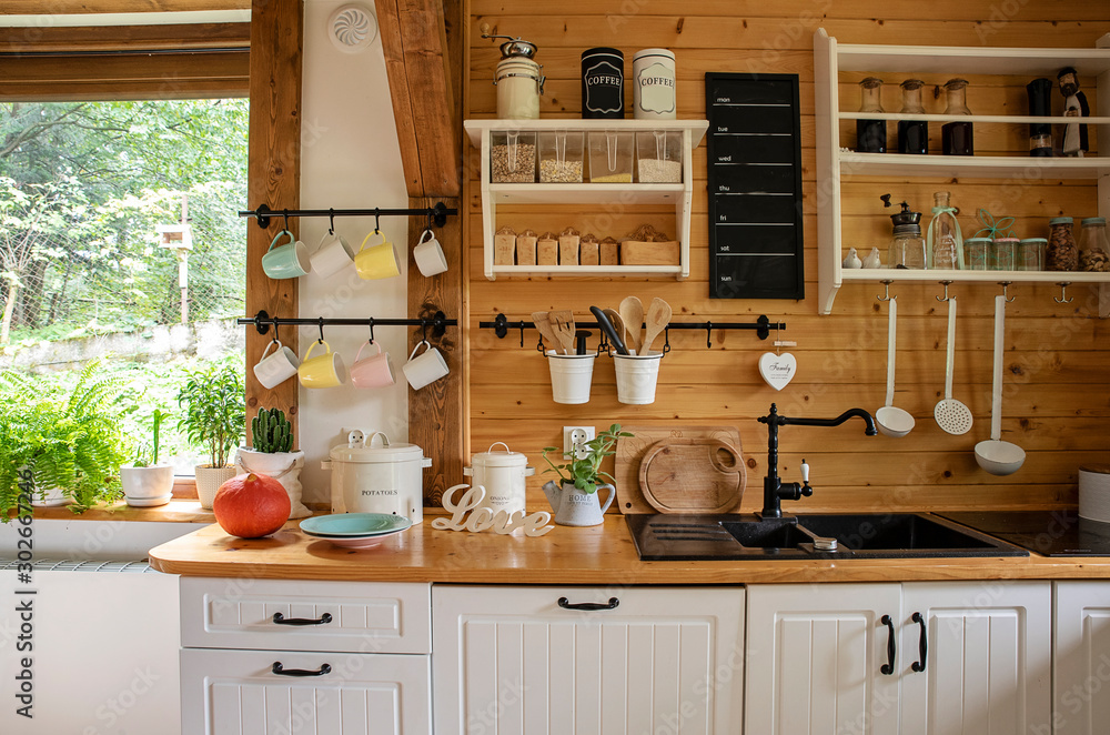 Wall mural interior of kitchen in rustic style with vintage kitchen ware and window. white furniture and wooden