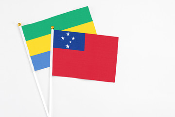 Samoa and Gabon stick flags on white background. High quality fabric, miniature national flag....