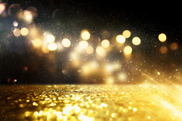 background of abstract glitter lights. gold and black. de focused
